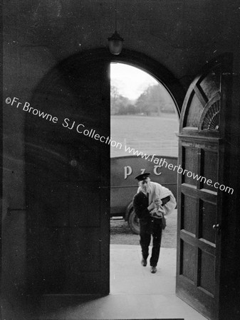 POSTMAN AT DOORWAY